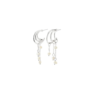 A pair of silver crescent moon dangle earrings with small cream-colored beads on a clean white background.