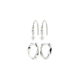 Silver earrings with pearl drops on a white background