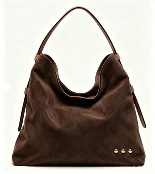 Brown suede handbag with gold accents on a white background