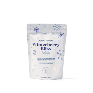 A stand-up pouch of Breathe Needle Winterberry Bliss Fiery Bath Soak, decorated with blue snowflakes on a white background.