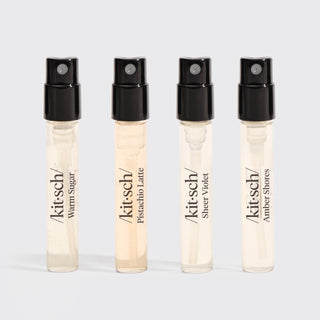 Four Kitsch perfume samples on a light gray background
