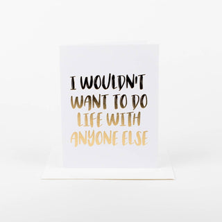 White card with black and gold text on a white background