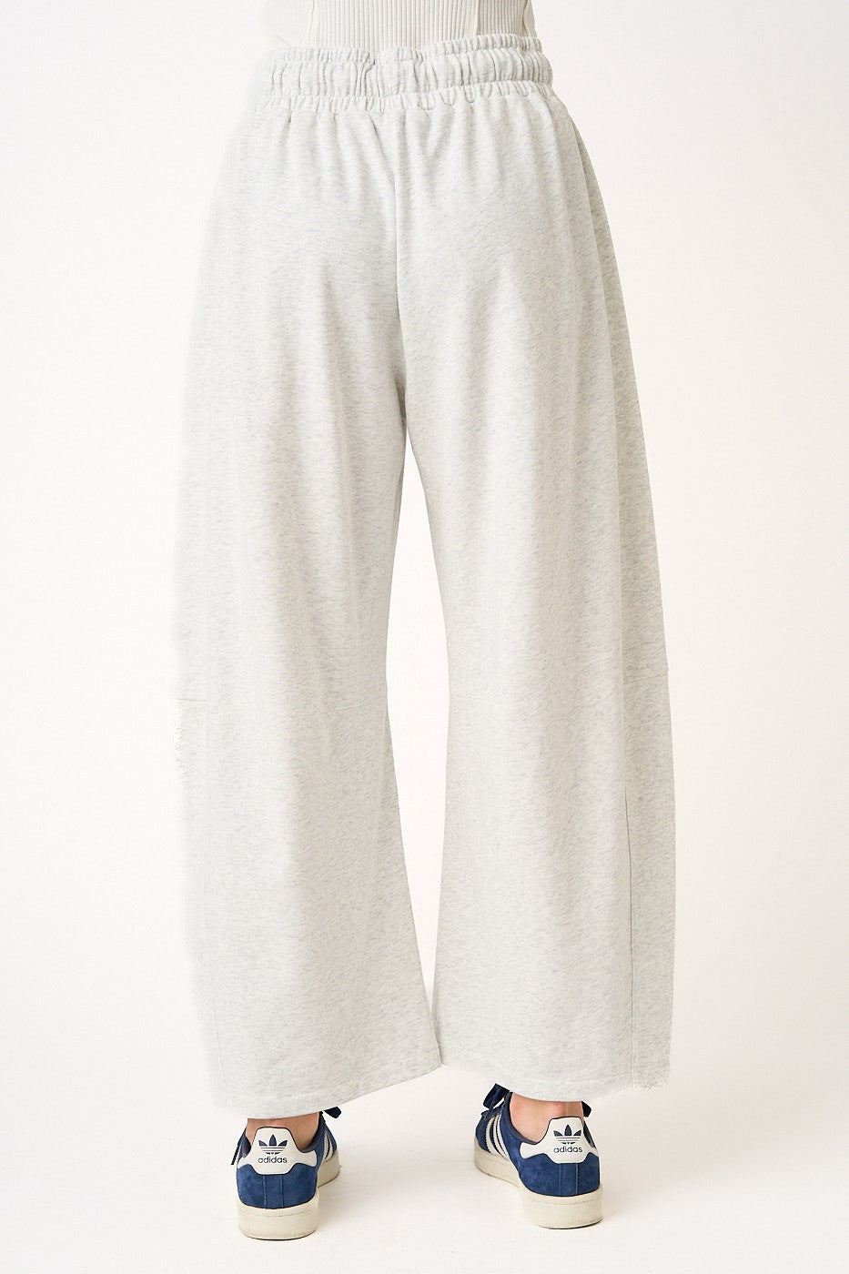 White wide-leg pants worn by a person on a white background