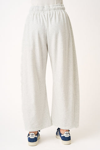 White wide-leg pants worn by a person on a white background