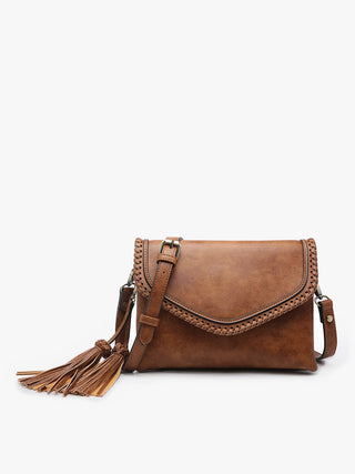 Brown leather handbag with tassel on a white background