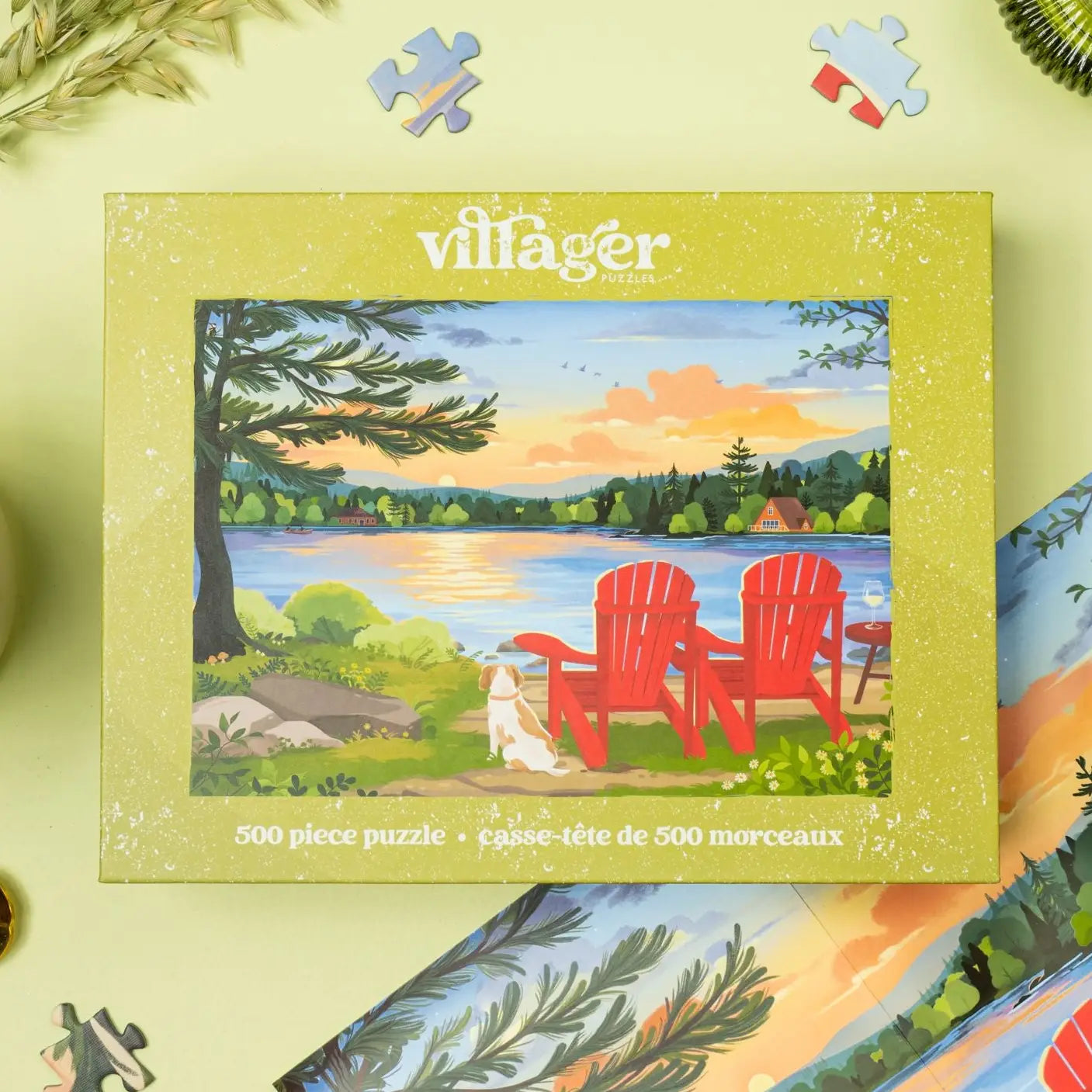 Villager 500 piece puzzle box with a scenic illustration of two red Adirondack chairs by a lake.