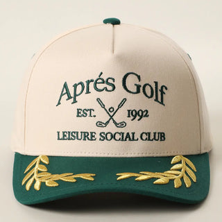 Beige and green cap with embroidered text and designs on a light gray background