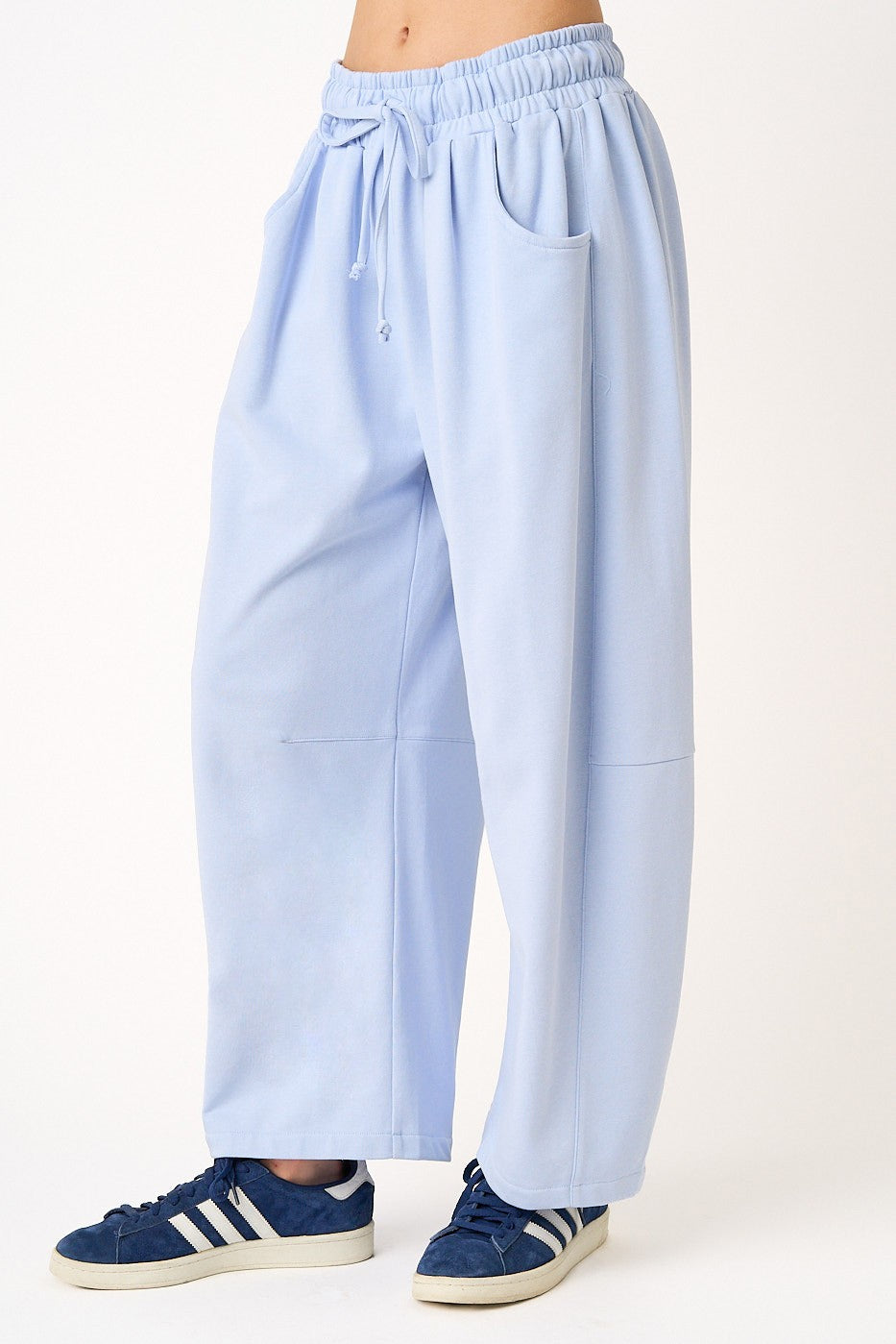Light blue pants worn by a person on a white background