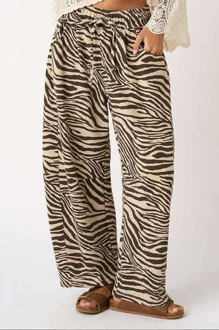 Zebra print pants worn by a person on a white background