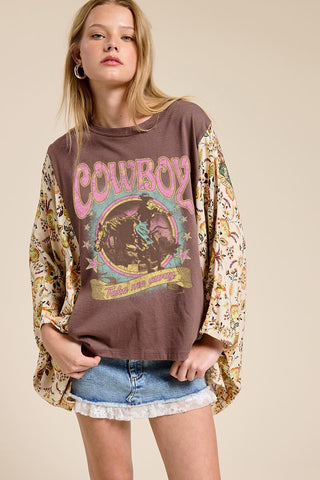 women wearing a a brown cowboy graphic tee with a floral boho sleeve. 