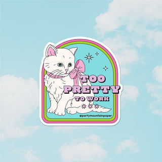 A sticker with a illustration of a white cat with a bow, and the text 'TOO PRETTY TO WORK'.