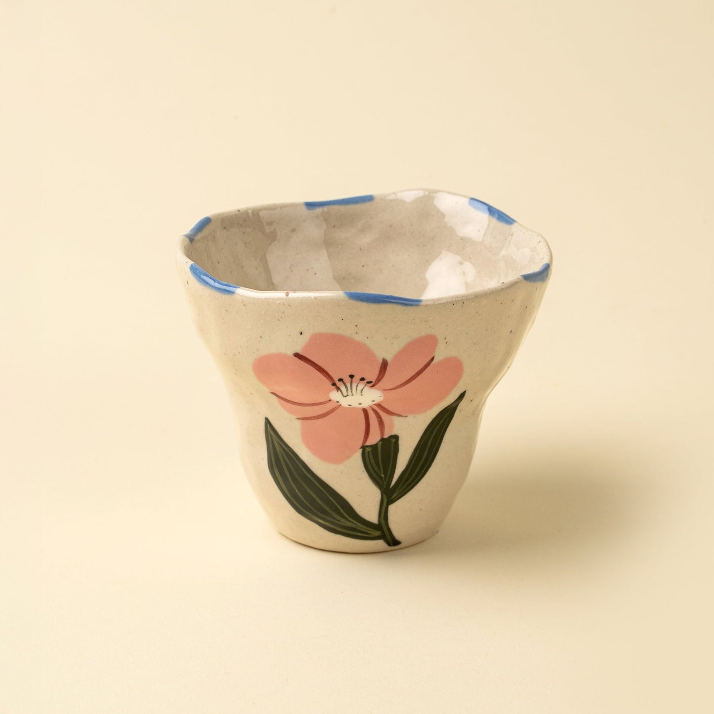 Ceramic cup with a floral design on a beige background