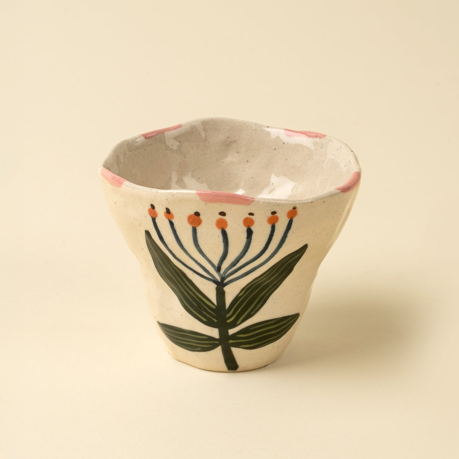 Ceramic cup with floral design on a beige background