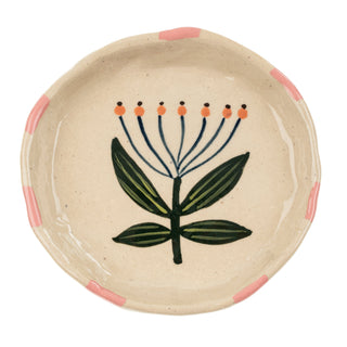 Ceramic plate with floral design on a beige background