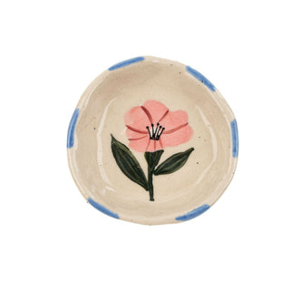 Ceramic bowl with a pink floral design on a white background