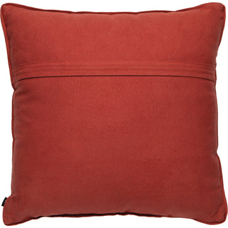 A square throw pillow in a rust red or terracotta color, made of a textured fabric like velvet or micro-suede, with a horizontal stitched seam across the top half.