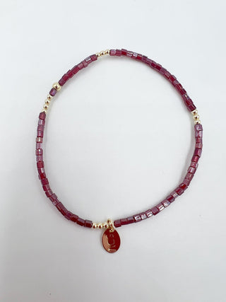 Necklace with red beads and a gold clasp on a white background