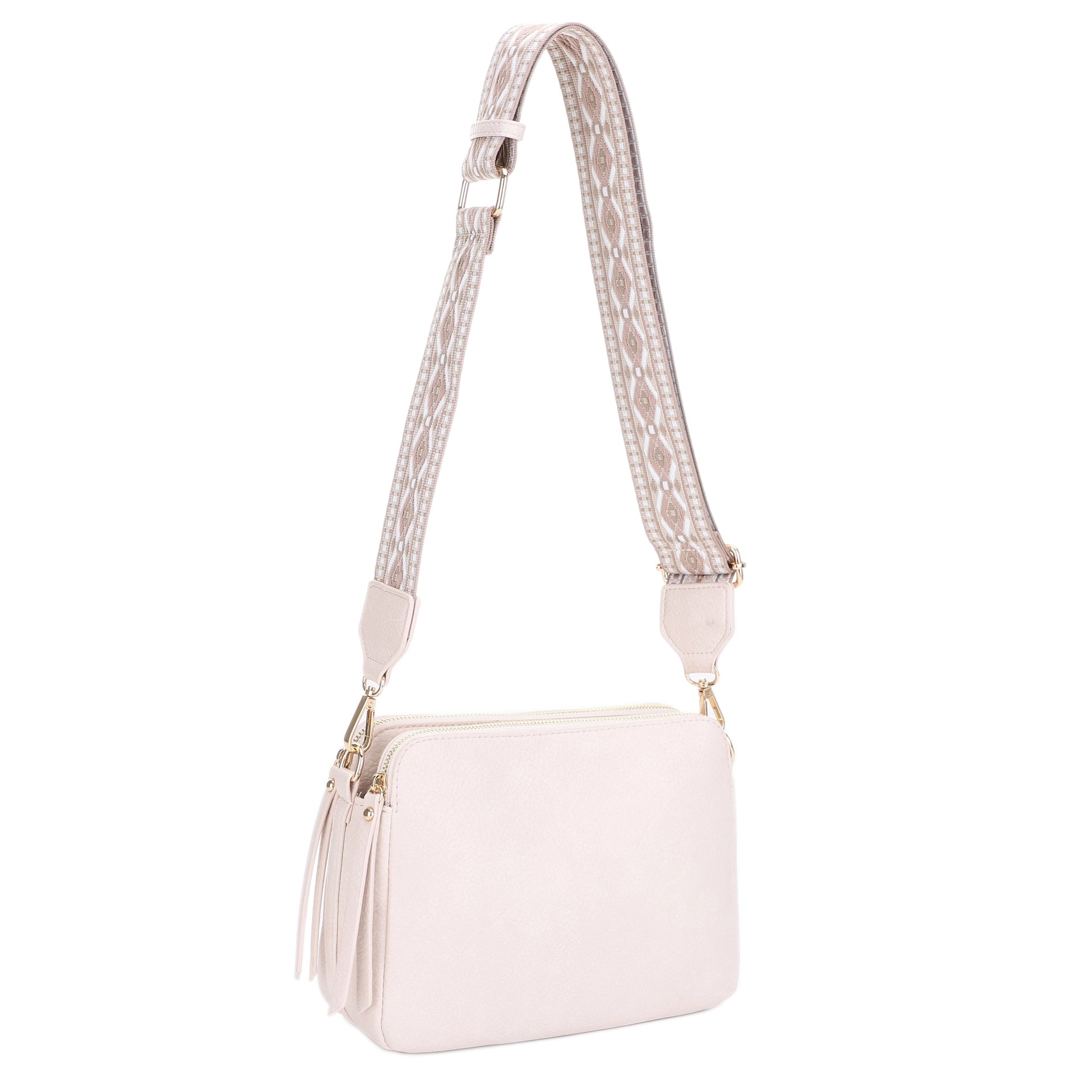A 3 compartment crossbody bag with a boho guitar strap.