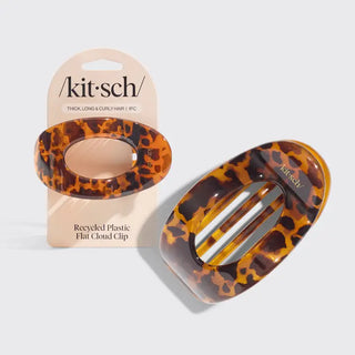 Tortoiseshell patterned hair clip with packaging on a light gray background