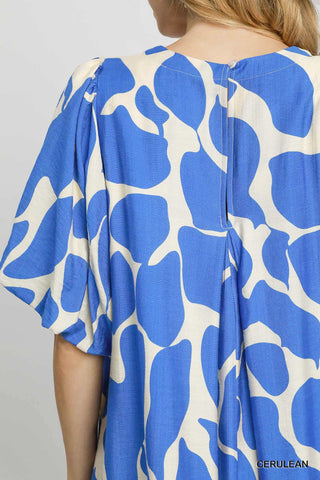 Blue and white patterned garment on a plain background
