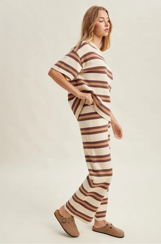 Women wearing a striped matching set against a neutral background.