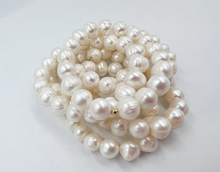 Pearl necklace on a light gray background
