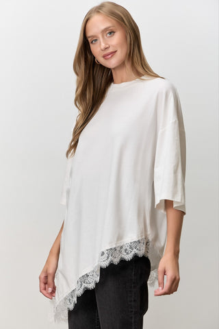 Women wearing a white t shirt with Lace Trim against a neutral background. 