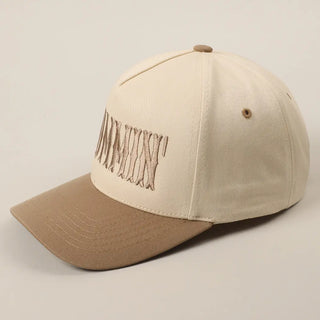 Beige and brown cap with embroidered design on a beige background