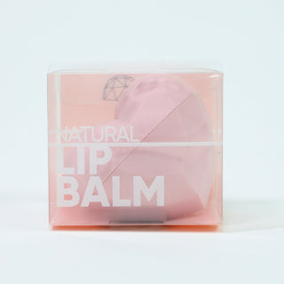 Pink lip balm in a clear packaging with 'Natural Lip Balm' text on a light gray background