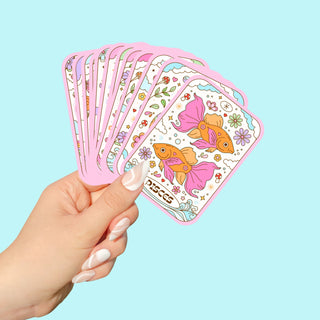 a person holding tarot card stickers