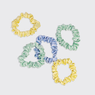 Set of colorful scrunchies on a light gray background