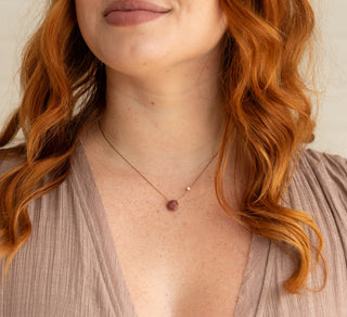 women wearing a nylon necklace with a crystal on it