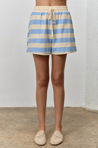 Women wearing a blue and cream striped short on a white background.