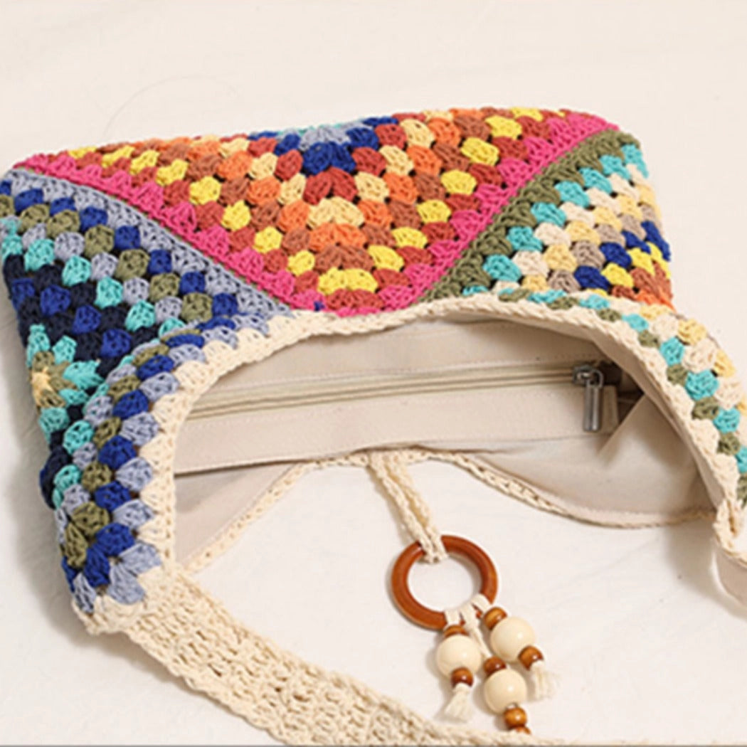 Colorful crocheted pouch with a wooden keychain on a white background