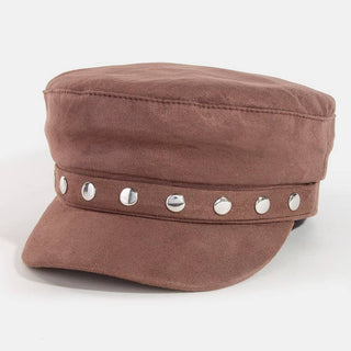 A brown suede-like newsboy cap with a curved brim and a horizontal band decorated with six silver-tone metal studs, shown on a plain white background.