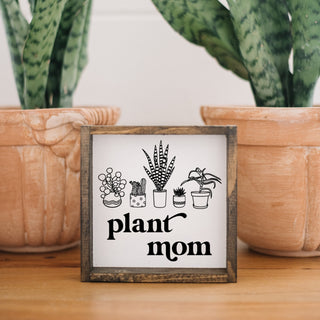 a wooden sign with plants and the phrase "plant mom"