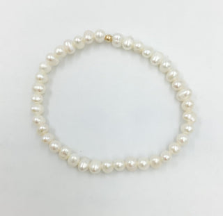 Pearl bracelet on a light gray background