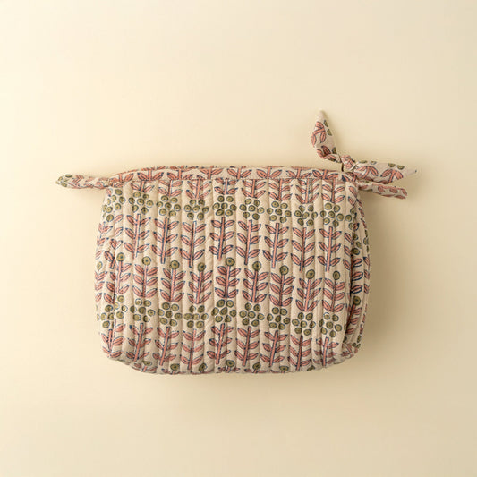 Fabric pouch with leaf pattern on a beige background
