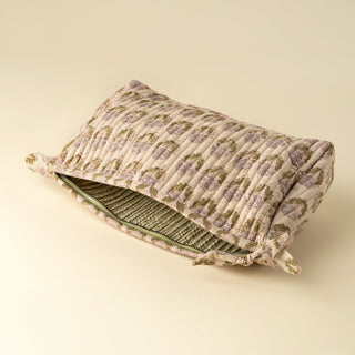 Floral-patterned pillow with a zipper on a beige background