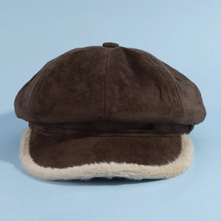 Brown cap with fur trim on a light blue background