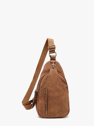 A brown faux-leather sling bag with a matching adjustable shoulder strap, featuring a front zippered pocket with a braided zipper pull, set against a plain white background.