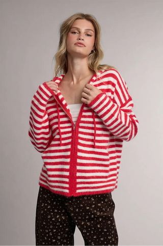 Women wearing a striped hoodie against a neutral background.