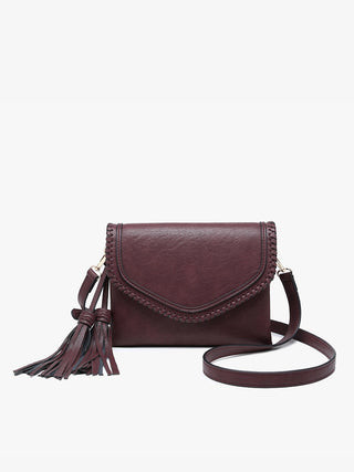 A dark green faux-leather crossbody bag with a flap front, decorative stitching, a tassel detail, and a matching adjustable shoulder strap, shown against a plain white background.