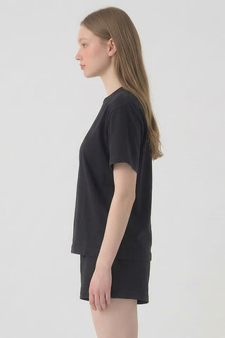Person wearing a black t-shirt and shorts on a white background