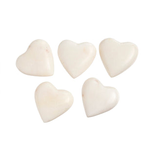 Five white heart-shaped objects on a white background