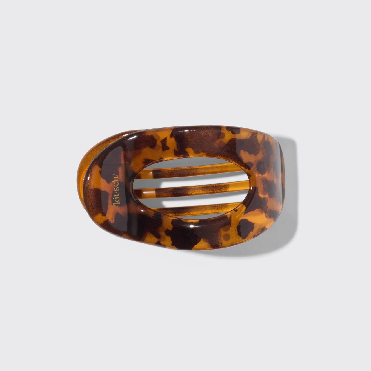 Tortoise shell hair clip on a light gray background