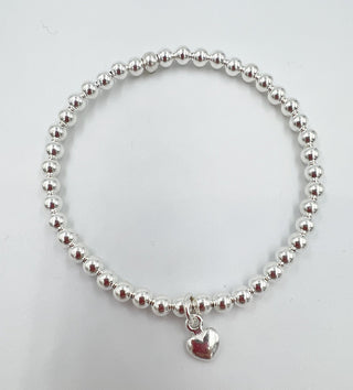 A silver-colored beaded bracelet with a sterling silver heart charm.