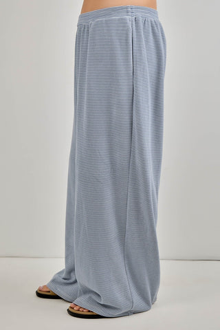 Blue and white striped pants on a plain background