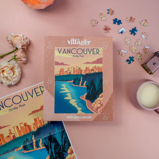 Vancouver-themed puzzle box with scattered puzzle pieces on a pink surface.