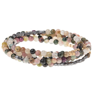 a beaded crystal wrap bracelet of necklace on a white background